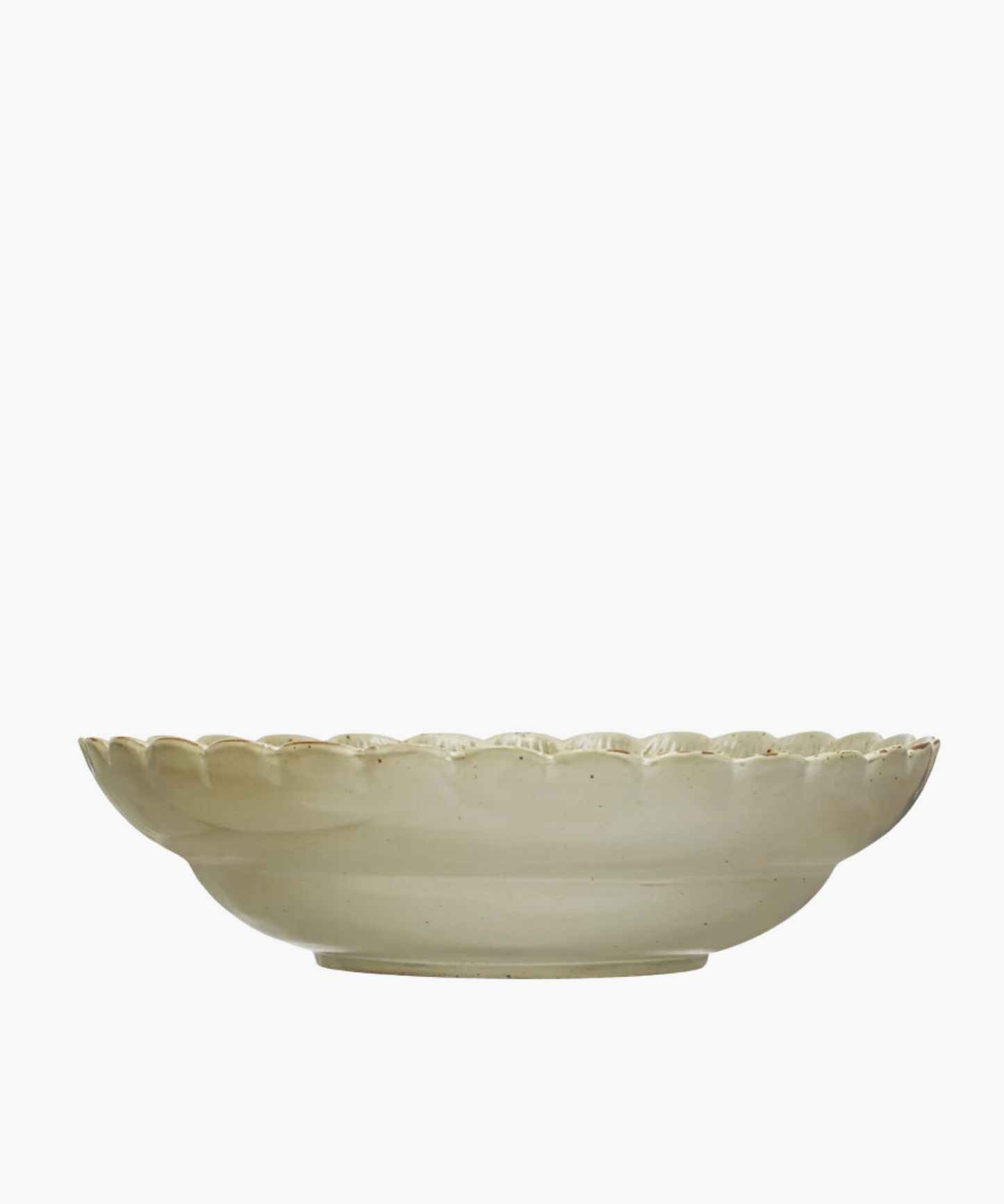 A Scandinavian-inspired stoneware bowl with a scalloped edge and a naturally variating reactive green glaze. The minimalist design gives an elegant and timeless appearance.