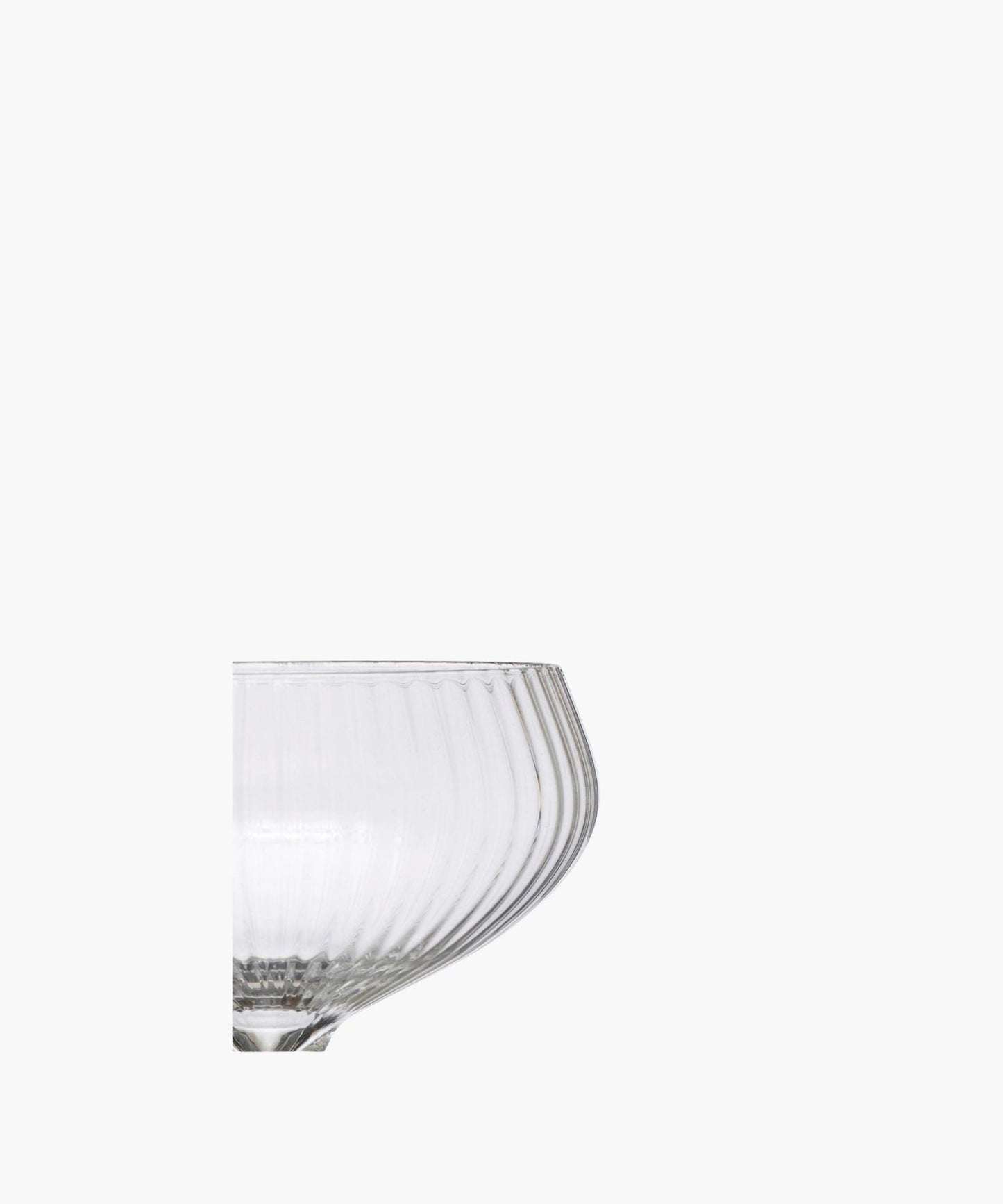 A detailed picture of a clear glass coupe highlighting the vertical ridges. It exudes sophistication and vintage charm.