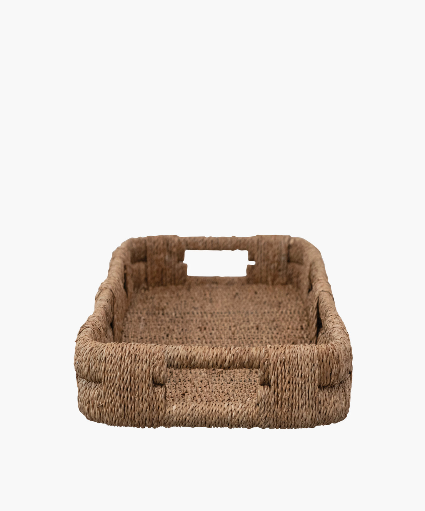 A long, rectangular woven wicker tray with short sides, displaying a natural brown color. It conveys a rustic, minimalist aesthetic.