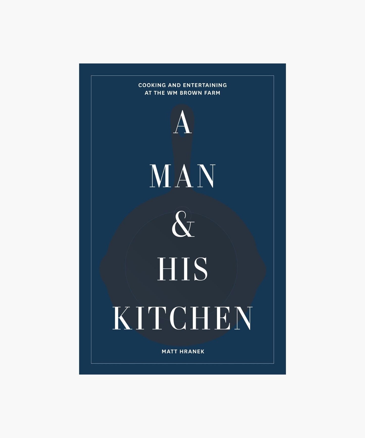 The cover of "A Man & His Kitchen" by Matt Hranek features a dark blue background with white text overlaying a silhouette of a skillet. The tone is elegant and inviting.