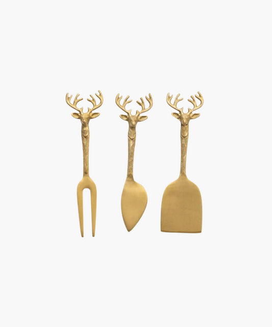 A set of three elegant cheese knives with gold deer head handles. Includes a fork, spreader, and chisel, conveying a rustic and festive tone.