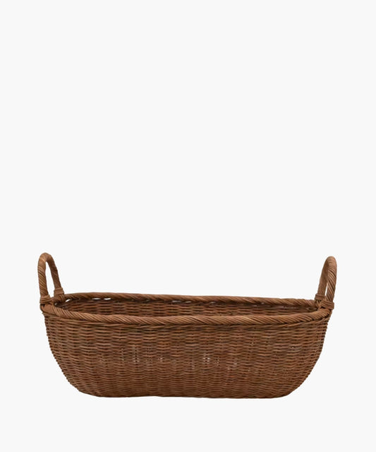 A handwoven wicker basket with two looped handles on either side featuring an organic oval shape and a natural brown finish. The basket has a natural, rustic appearance.