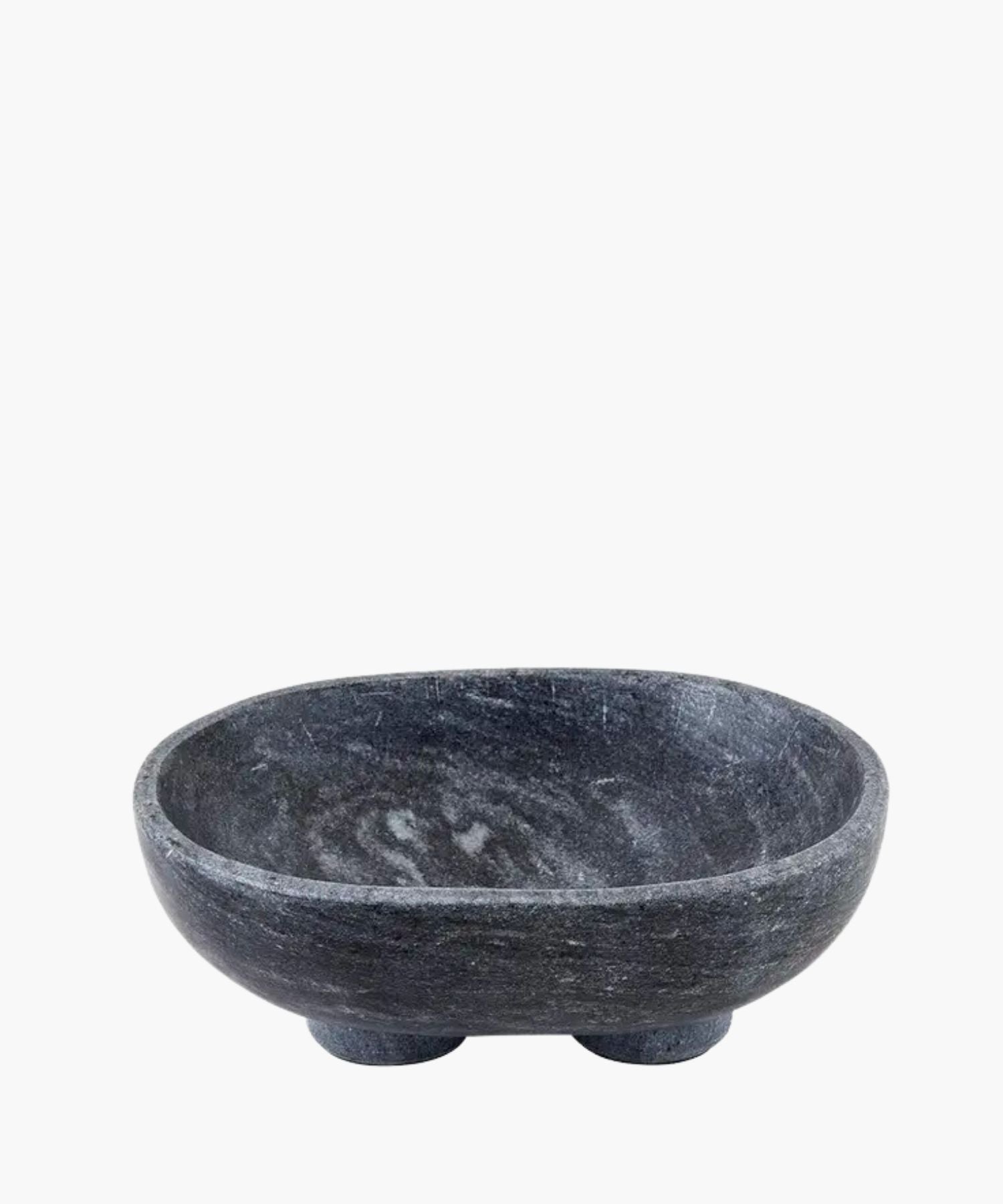 A smooth, dark charcoal gray marble bowl with subtle white veining, sits on two rounded feet. The bowl has a minimalist and modern design.