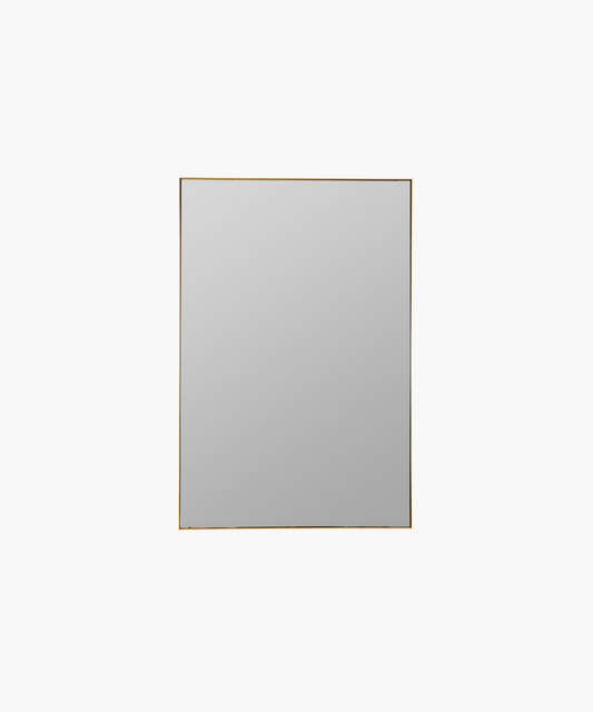 A minimalist rectangular mirror with a thin gold frame, set against a plain white background. It conveys a modern and sleek aesthetic.