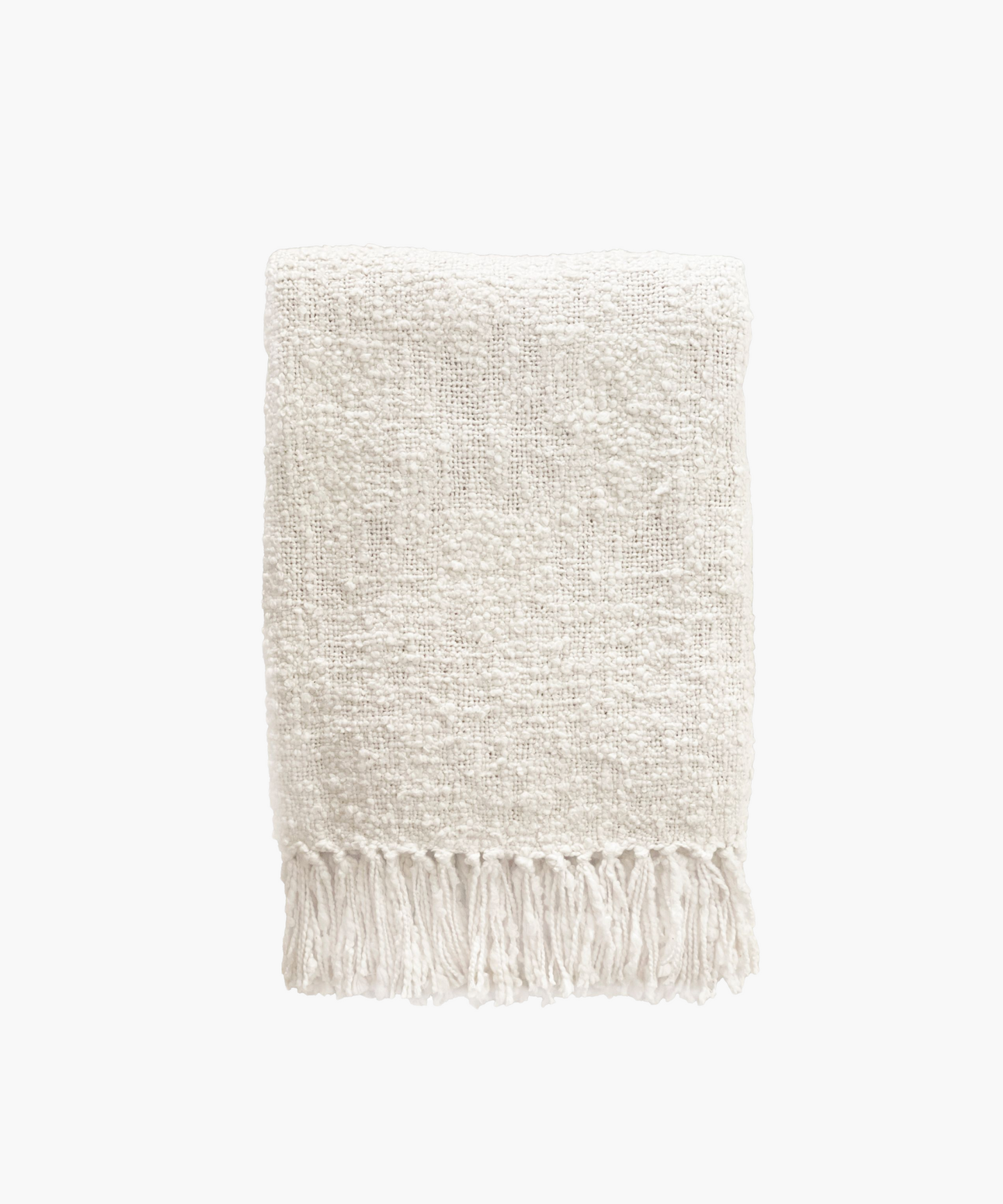 A soft, ivory colored woven throw blanket with a textured pattern and fringed edges, conveying a cozy and inviting feel. 