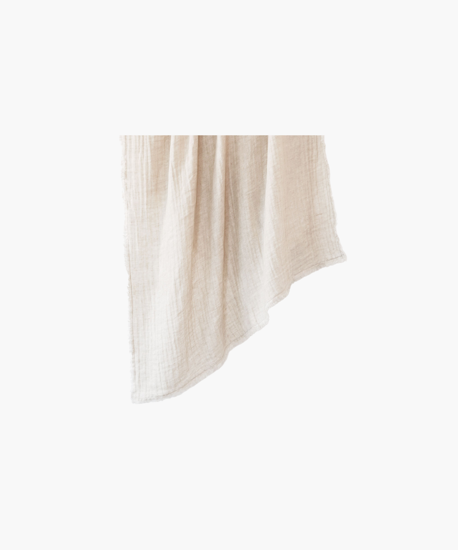 A soft, beige linen throw blanket is neatly hanging against a plain background, showcasing a delicate fringe along the edges, conveying a cozy and elegant feel.