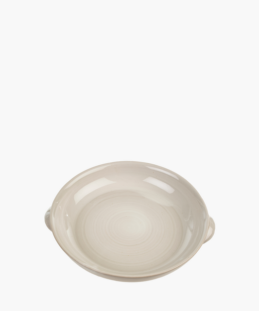 A smooth, beige ceramic bowl with subtle concentric circles and two small handles, conveying simplicity and elegance. The tone is minimalistic.