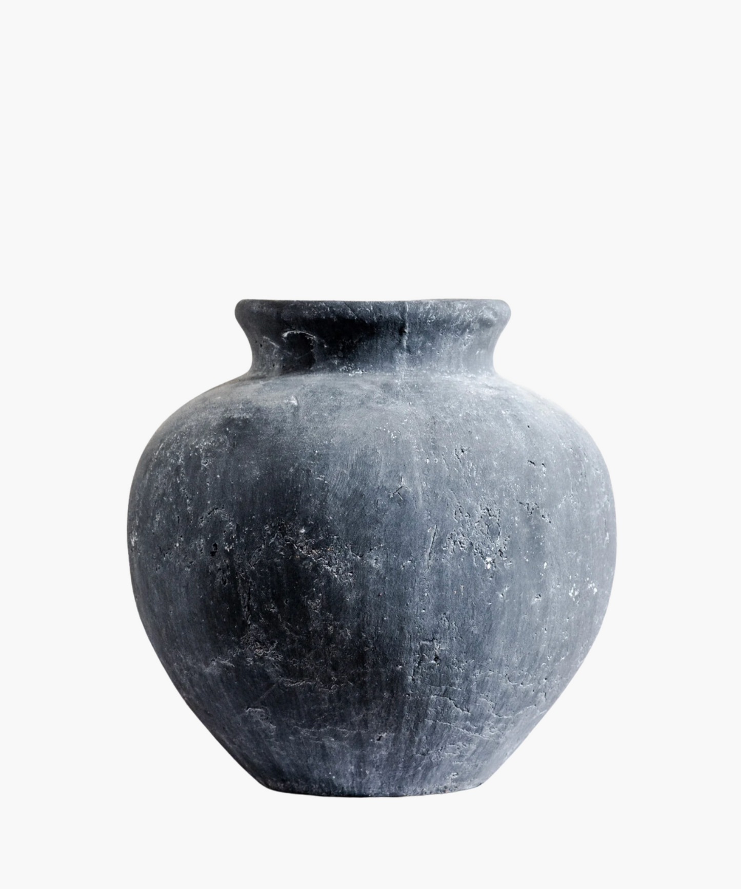 A large, round, weathered gray clay vase with a narrow neck, displaying rough texture and subtle speckles, set against a plain white background.