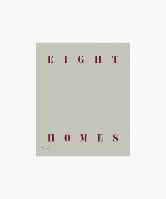 Plain gray cover with the title "Eight Homes" written in bold, dark red letters at the top and bottom. Minimalist and elegant design.