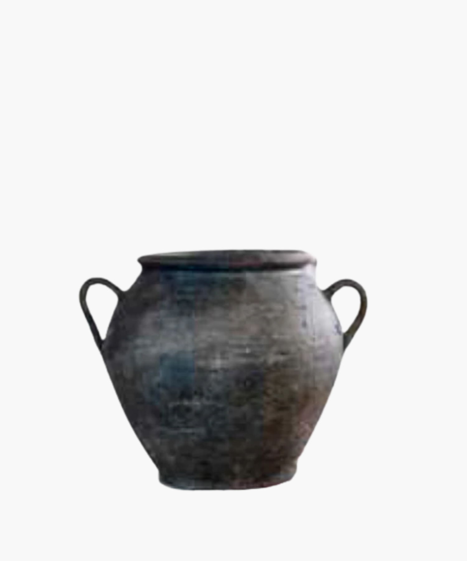 Aged, dark clay pot with two curved handles on each side. The surface is textured, showing signs of wear, conveying a sense of history and rustic charm.