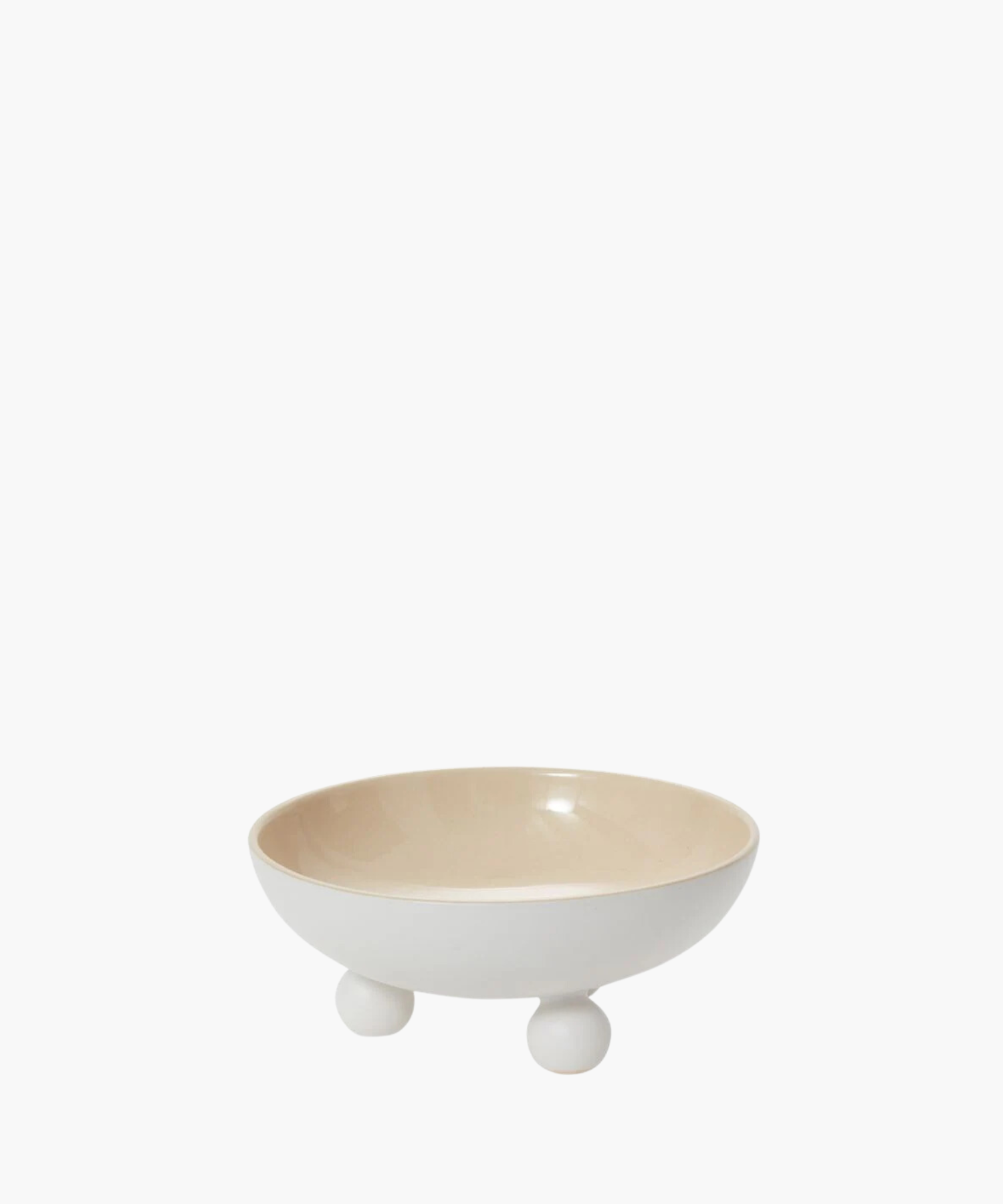 A minimalist white ceramic bowl with a smooth, glossy finish sits on three round feet. The interior is a light beige, conveying simplicity and elegance.