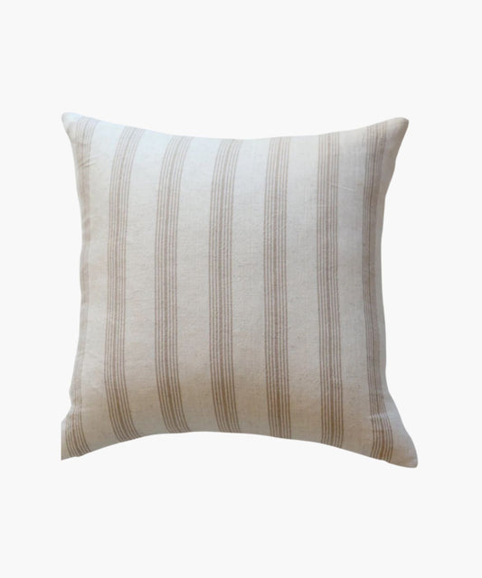 A square pillow cover with vertical tan woven stripes on a cream cotton fabric background. The design conveys a neutral and calming tone, suitable for various decor styles.