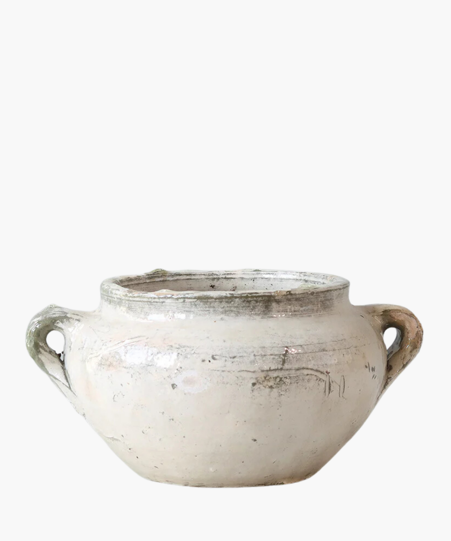 A rustic, cream-colored ceramic pot with two handles on each side. The surface is worn and mildly textured, conveying an antique feel.