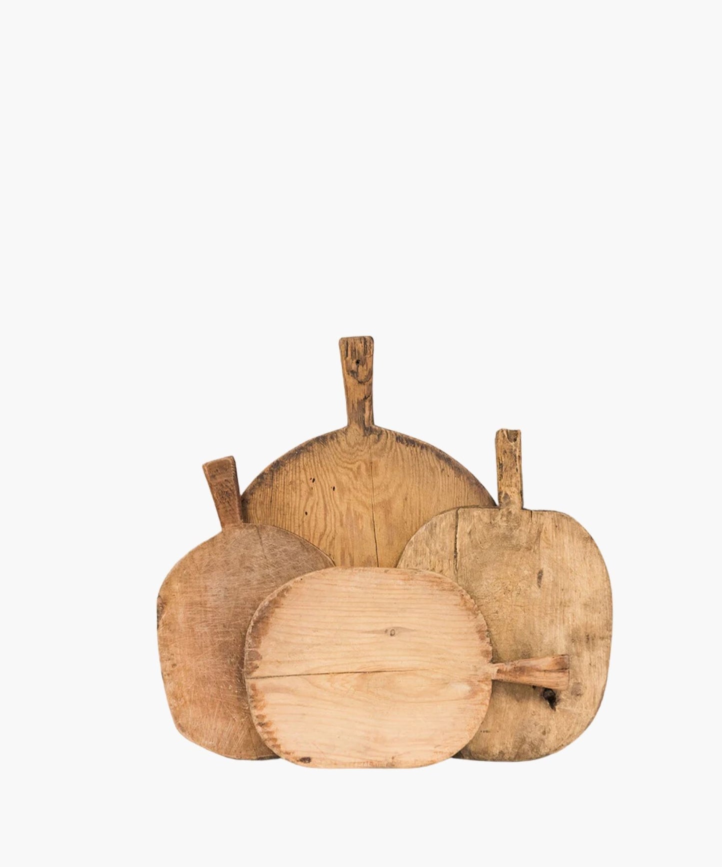 Four rustic, wooden cutting boards of varying shapes and sizes overlap. Their worn texture suggests frequent use, conveying a homely, vintage feel.