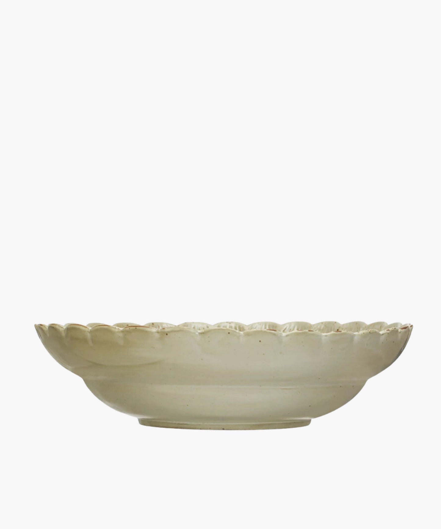 A Scandinavian-inspired stoneware bowl with a scalloped edge and a naturally variating reactive green glaze. The minimalist design gives an elegant and timeless appearance. 