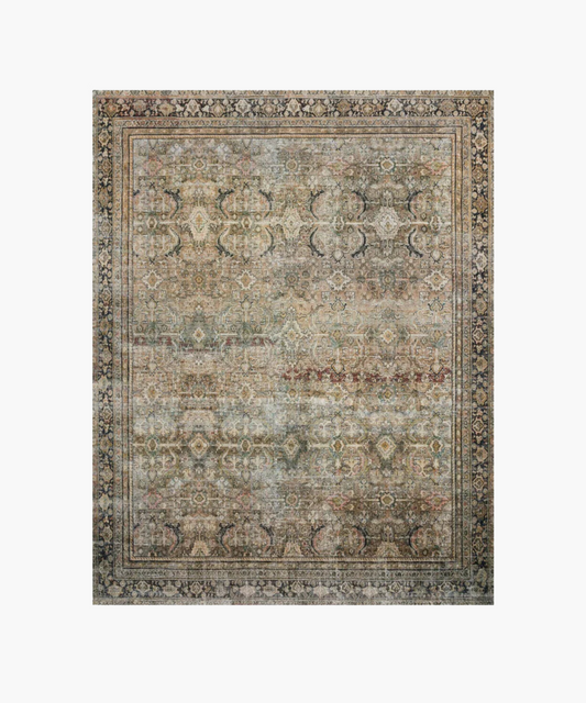 An antique-style rug with intricate floral and geometric patterns in muted earth tones, surrounded by a decorative border, creating an elegant vintage look.