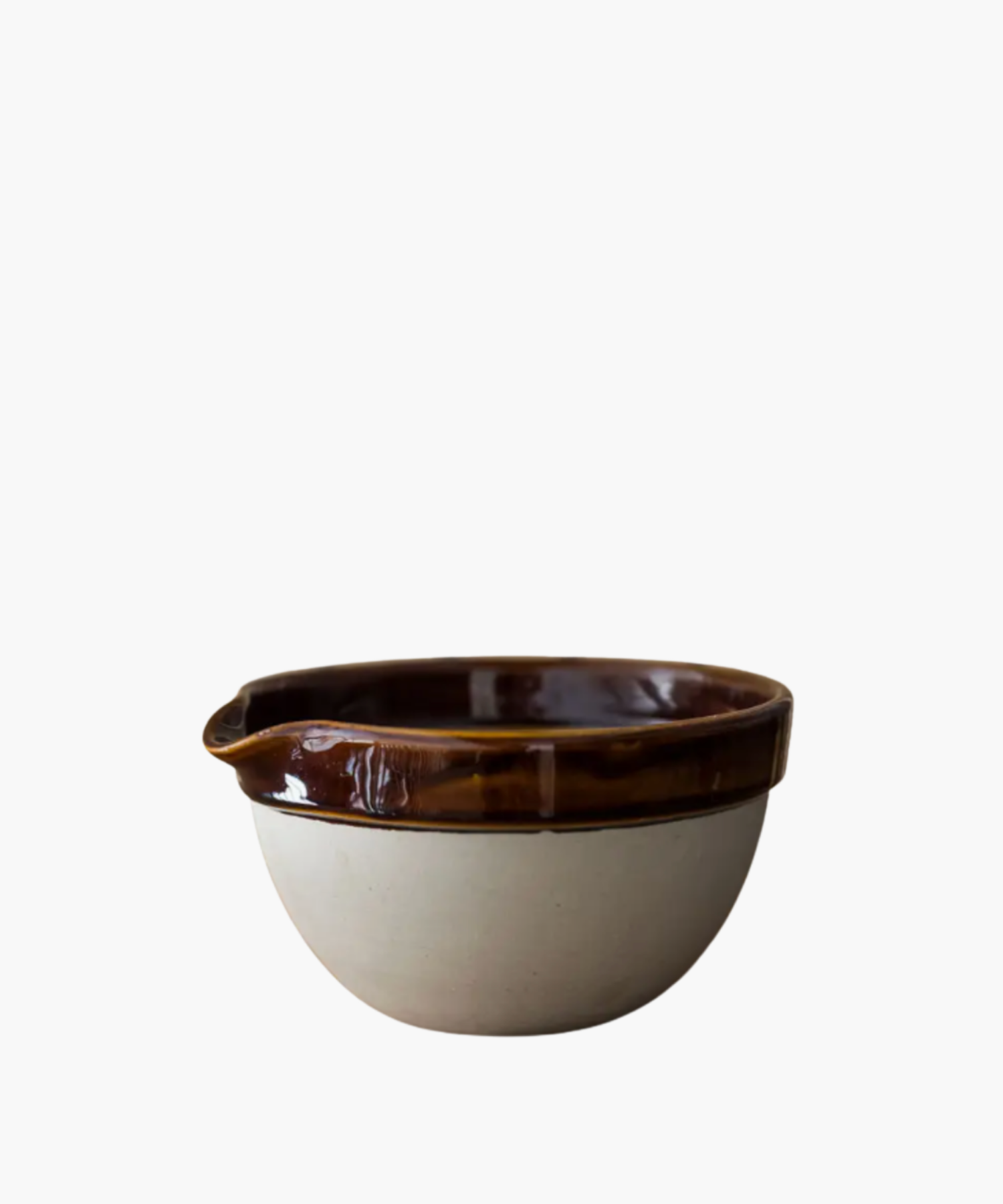 A ceramic bowl with a glossy brown rim and matte beige exterior. The design is rustic and visually pleasing.