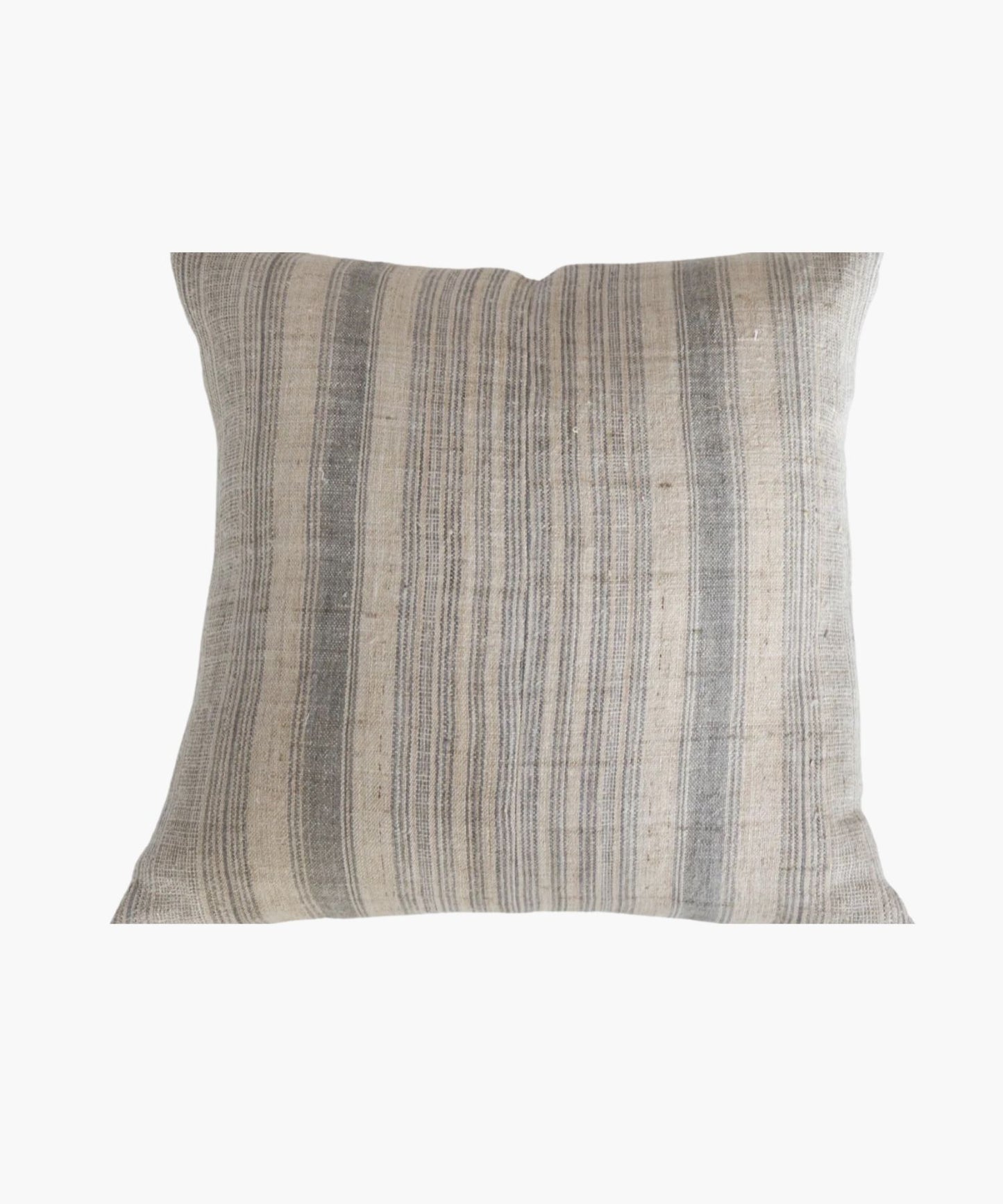 A square pillow cover with a neutral hemp background features vertical grey and blue stripes. The texture appears soft and slightly textured, conveying a cozy and rustic feel.