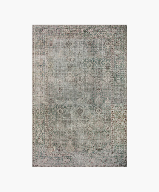 Vintage-style rug with a faded, intricate floral pattern in muted green and gray tones, featuring a decorative border. It conveys an antique, elegant feel.