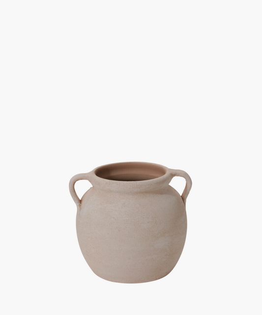 A rustic, beige clay pot with two handles and a wide opening. The surface is textured, conveying an earthy, handmade feel. The tone is simple and organic.