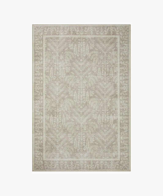 A beige area rug with an intricate floral and leaf pattern bordered by a thicker floral edge. The design is symmetrical and elegant, adding a soft, classic touch.