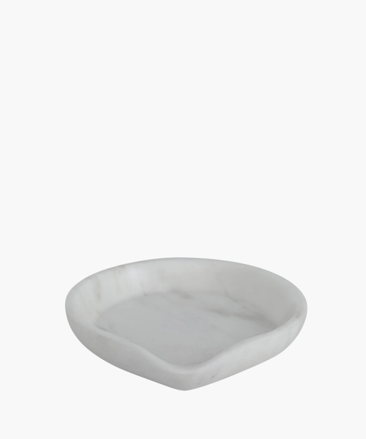 A smooth, round white marble dish or spoon rest. Its minimalist design and soft curves create an elegant, serene appearance.