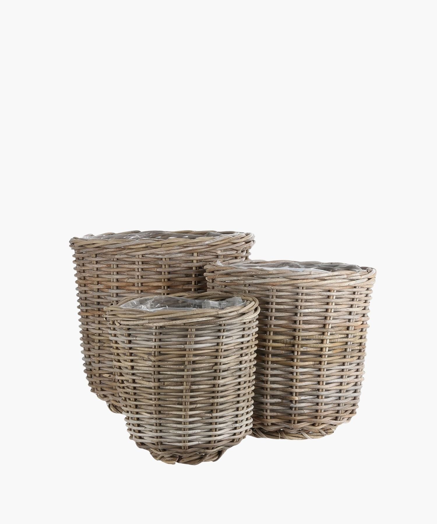 Three round wicker baskets of various sizes are shown against a white background conveying a natural, rustic appearance.