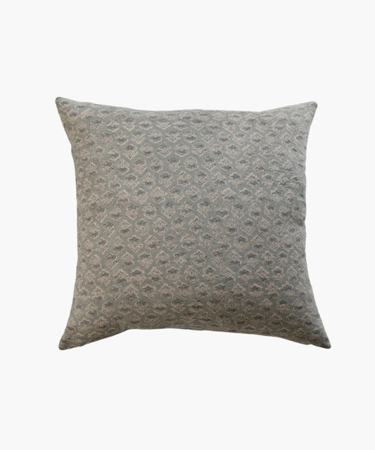 A square pillow with a subtle, intricate floral pattern in muted blue and gray tones. The design is elegant, conveying a calm and cozy atmosphere.