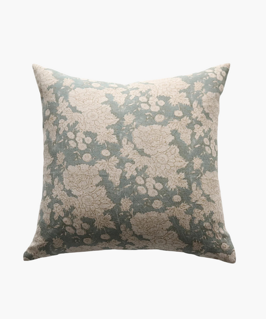 A square pillow with a vintage floral pattern featuring beige flowers on a muted teal background. The design exudes a calm and classic feel.