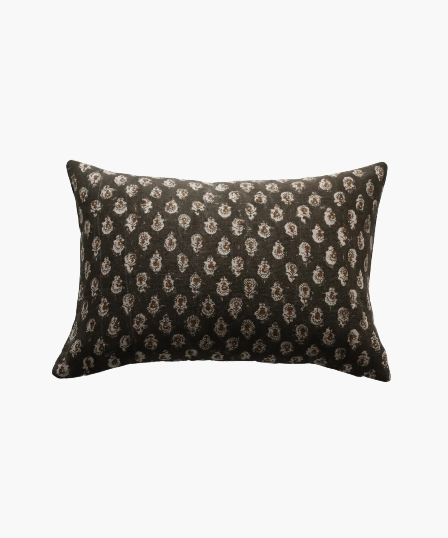 A rectangular pillow with a dark brown background features a pattern of small, intricate white floral designs, conveying a cozy and elegant feel.