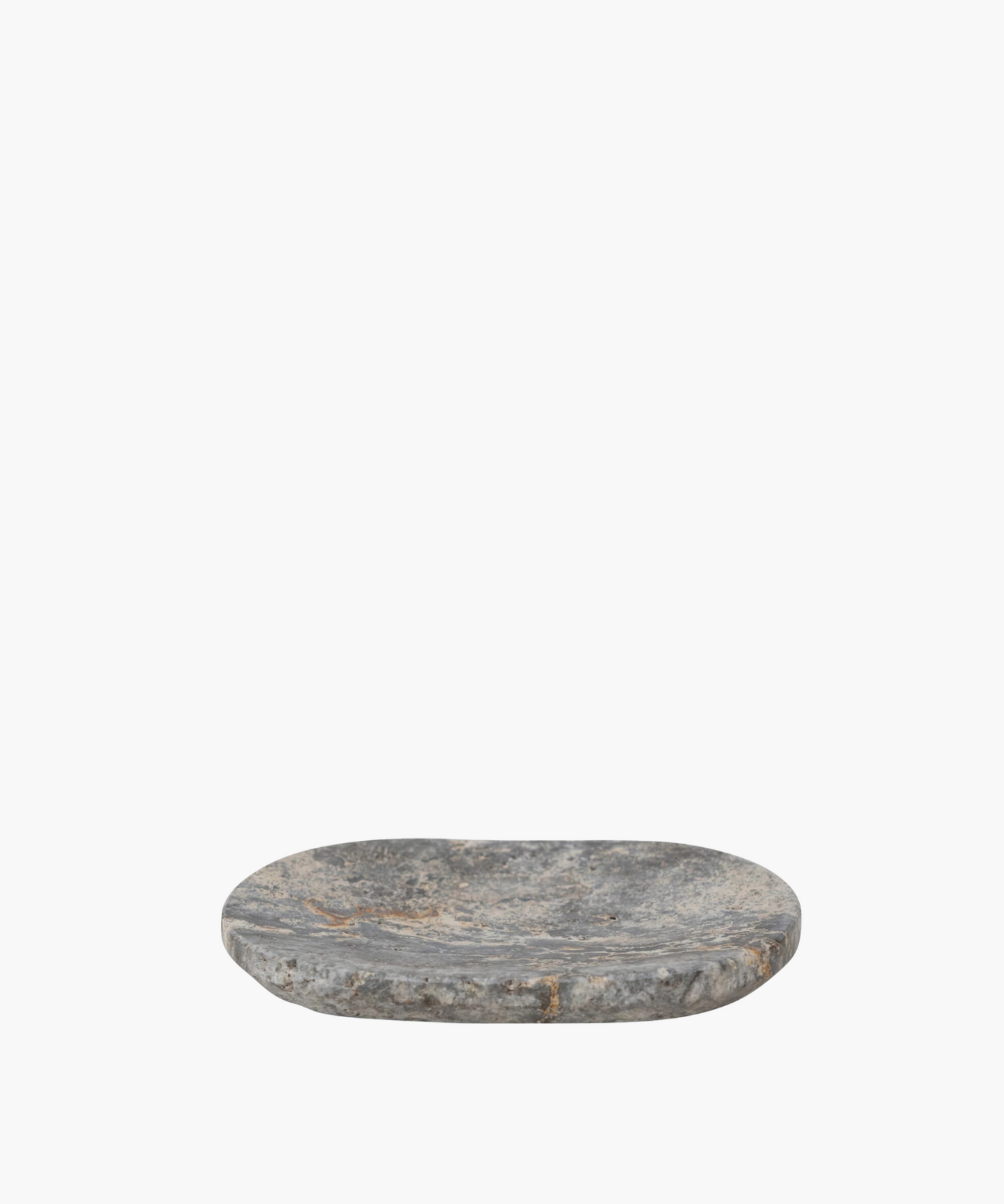 Oval shaped travertine soap dish with a rough, textured surface in shades of gray and hints of brown. It conveys a rustic, natural, and minimalist aesthetic.