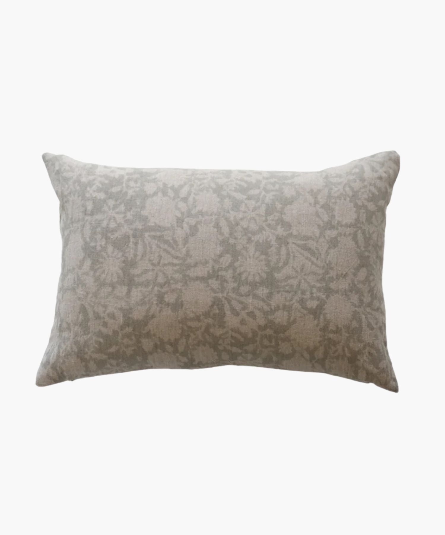 A rectangular or lumbar pillow with a subtle floral pattern in soft grey tones on a natural linen fabric. The design is delicate, creating a cozy and elegant feel.