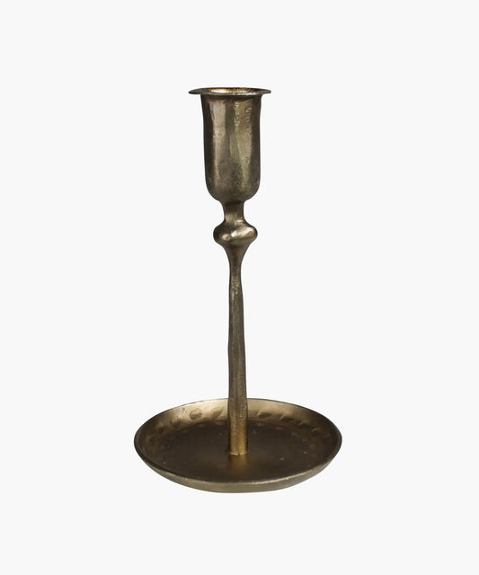 Antique inspired brass plated candle holder with a textured surface sitting on a circular base. 