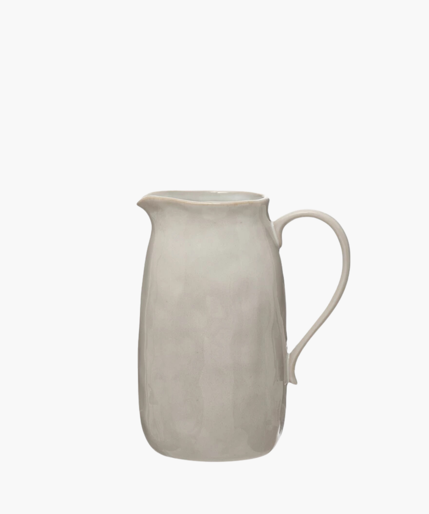 A simple, elegant beige ceramic pitcher with a smooth curved handle and a subtly textured surface, evoking a minimalist and classic design.