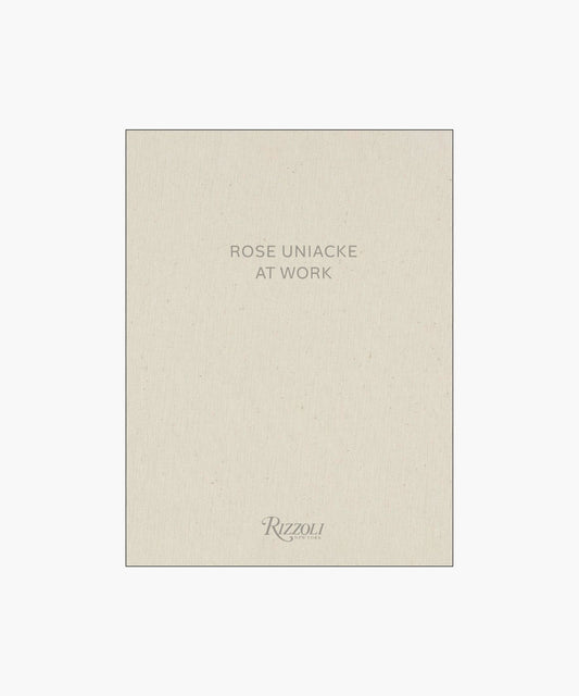 Cover of the book "Rose Uniacke at Work," featuring a minimalist design with beige fabric texture and gray text.