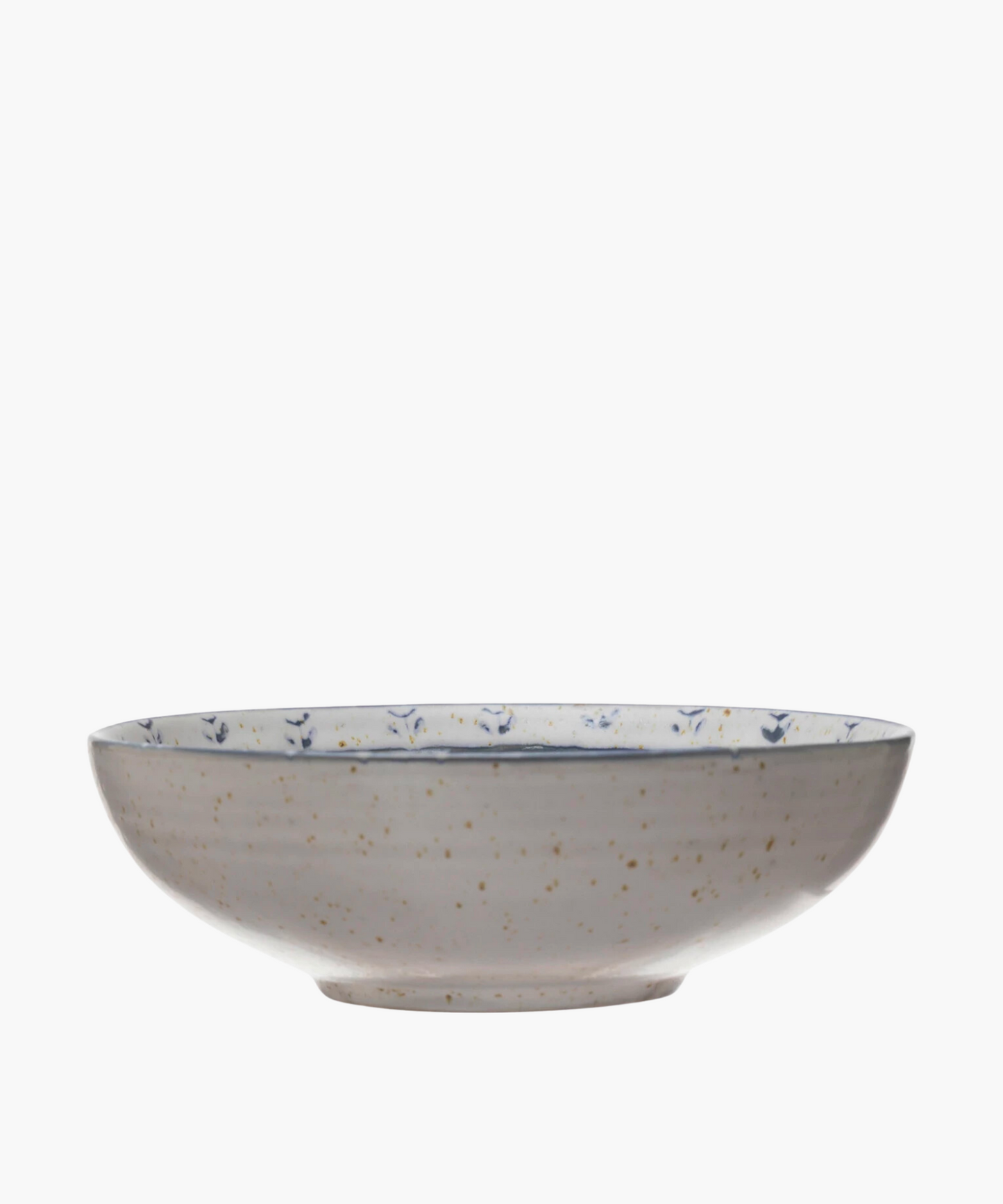 A speckled ceramic bowl with blue floral patterns inside. The off-white surface and wide, shallow shape give a rustic, elegant feel.