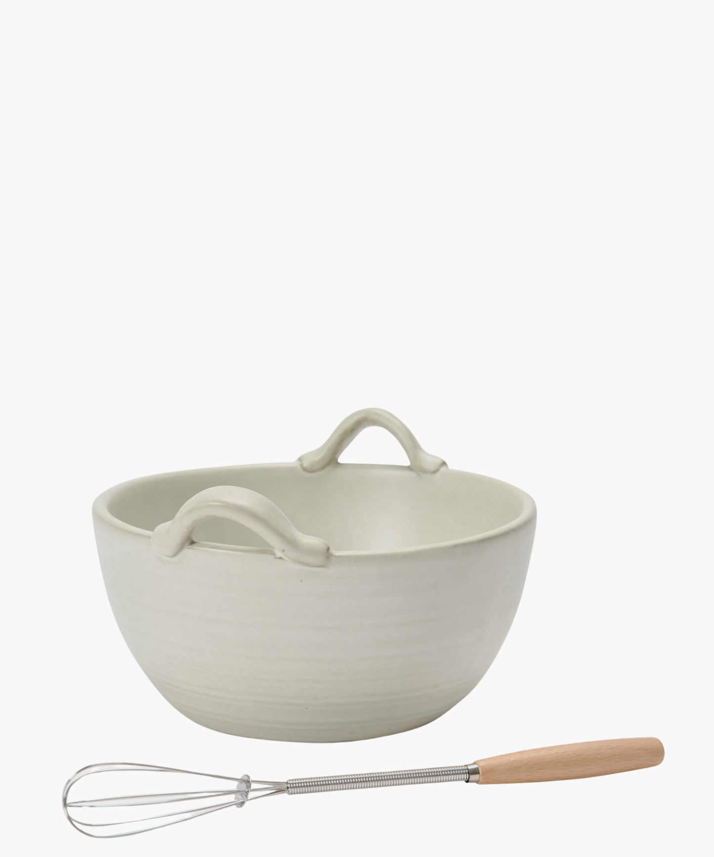 Cream stoneware bowl with a wooden handle whisk.