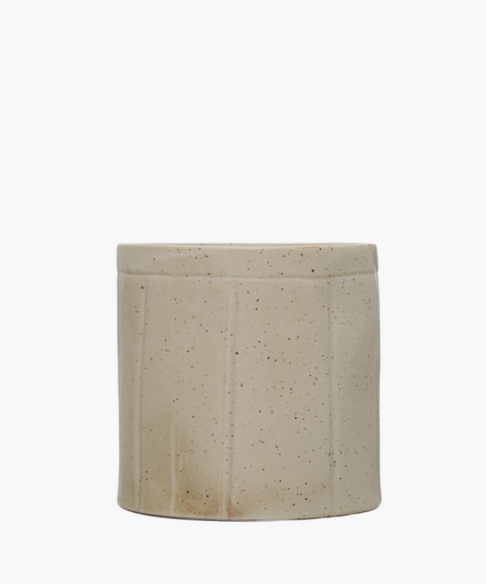 A beige ceramic stoneware crock with vertical ridges and a speckled texture. The simple, rustic design conveys an earthy, minimalist aesthetic.