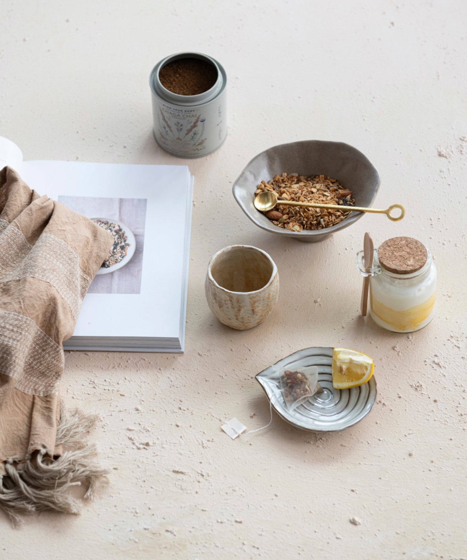 Embossed stoneware dish or spoon rest with reactive glaze styled with kitchen wares. 