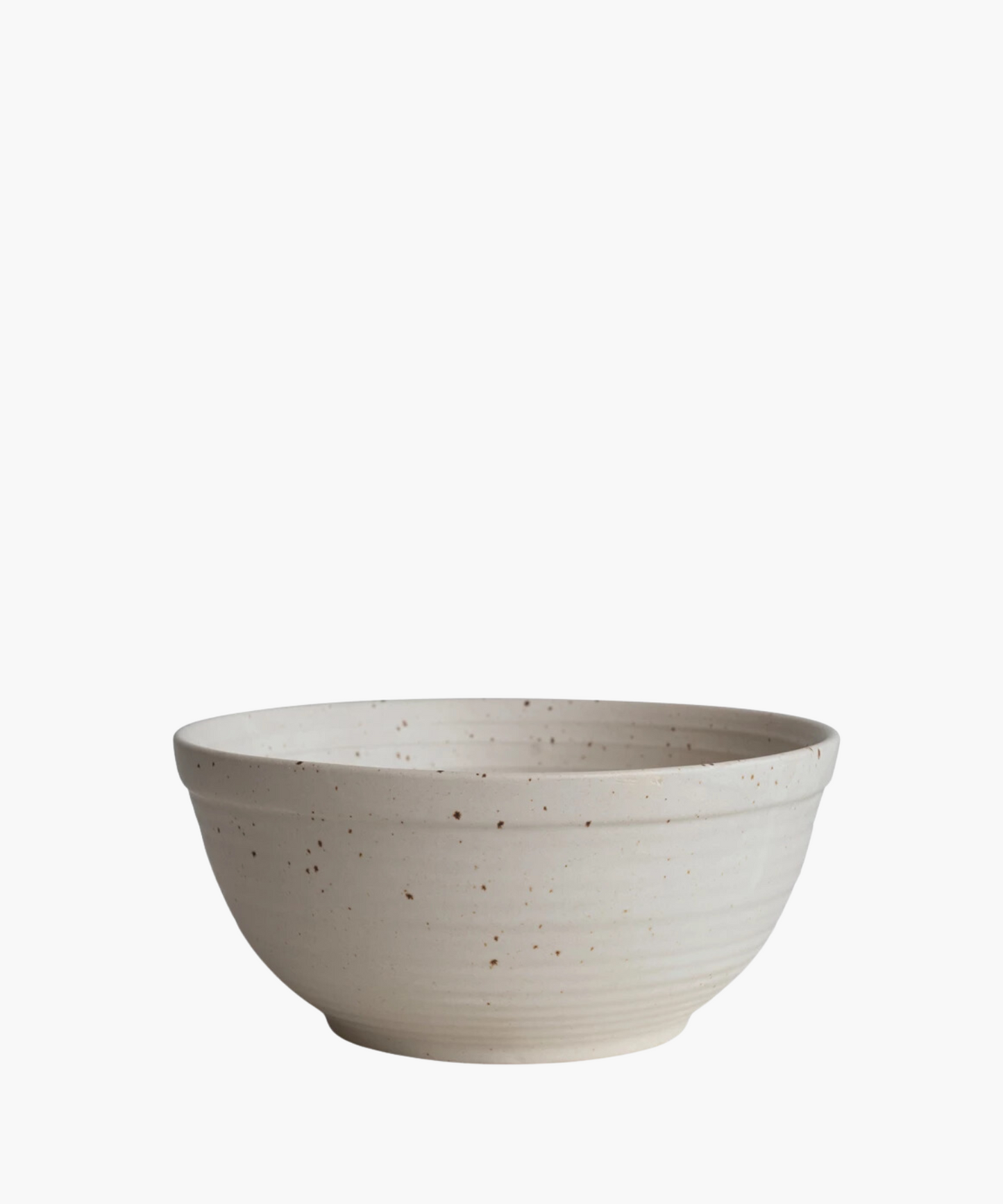 A beige ceramic bowl with a speckled pattern and a smooth, rounded shape. The bowl's minimalistic design conveys a rustic, handcrafted aesthetic.