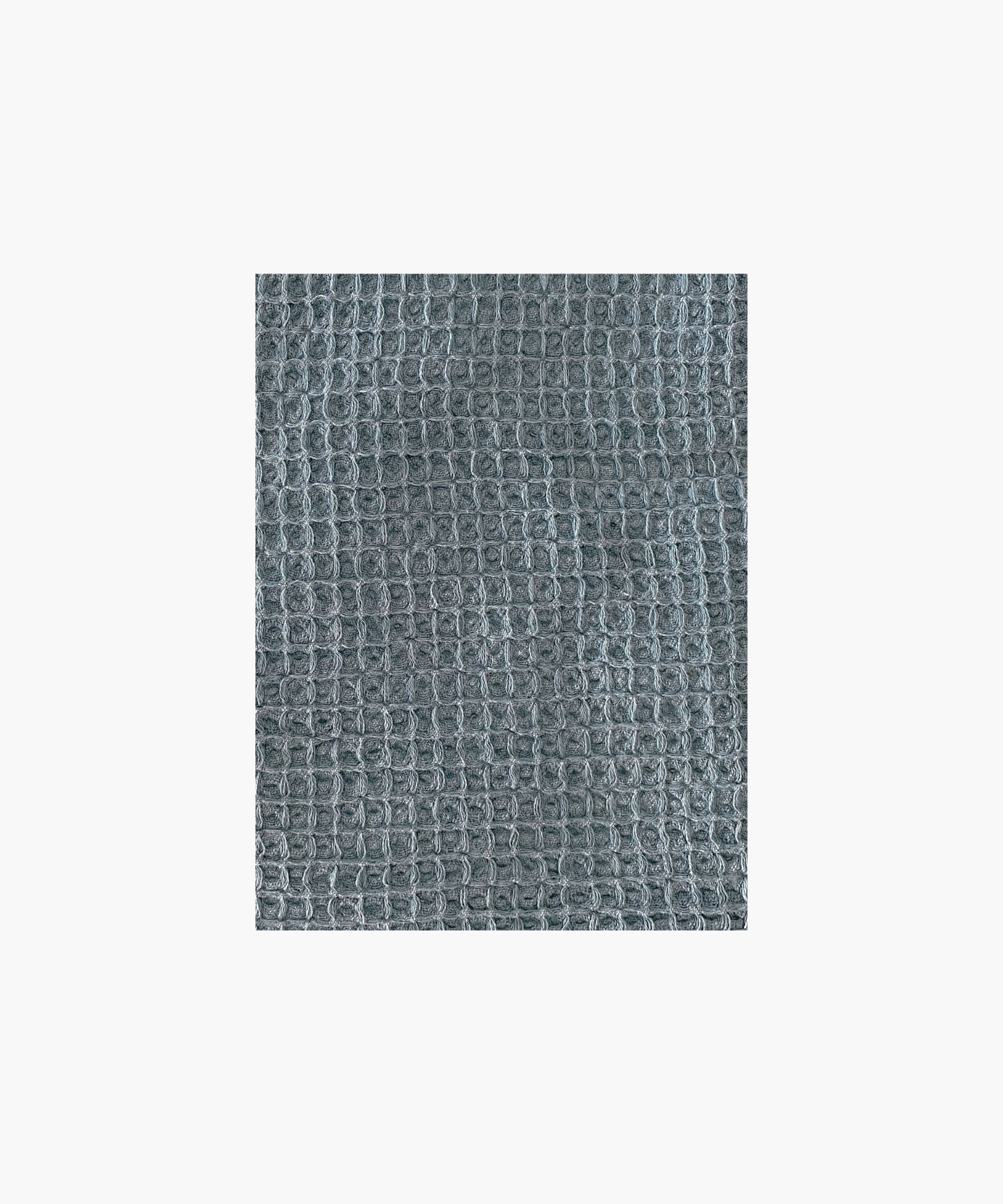 Close up of the vintage blue waffle-textured throw blanket highlighting the texture and color. The soft material conveys a cozy, inviting feel. Suitable for any living room or bedroom.