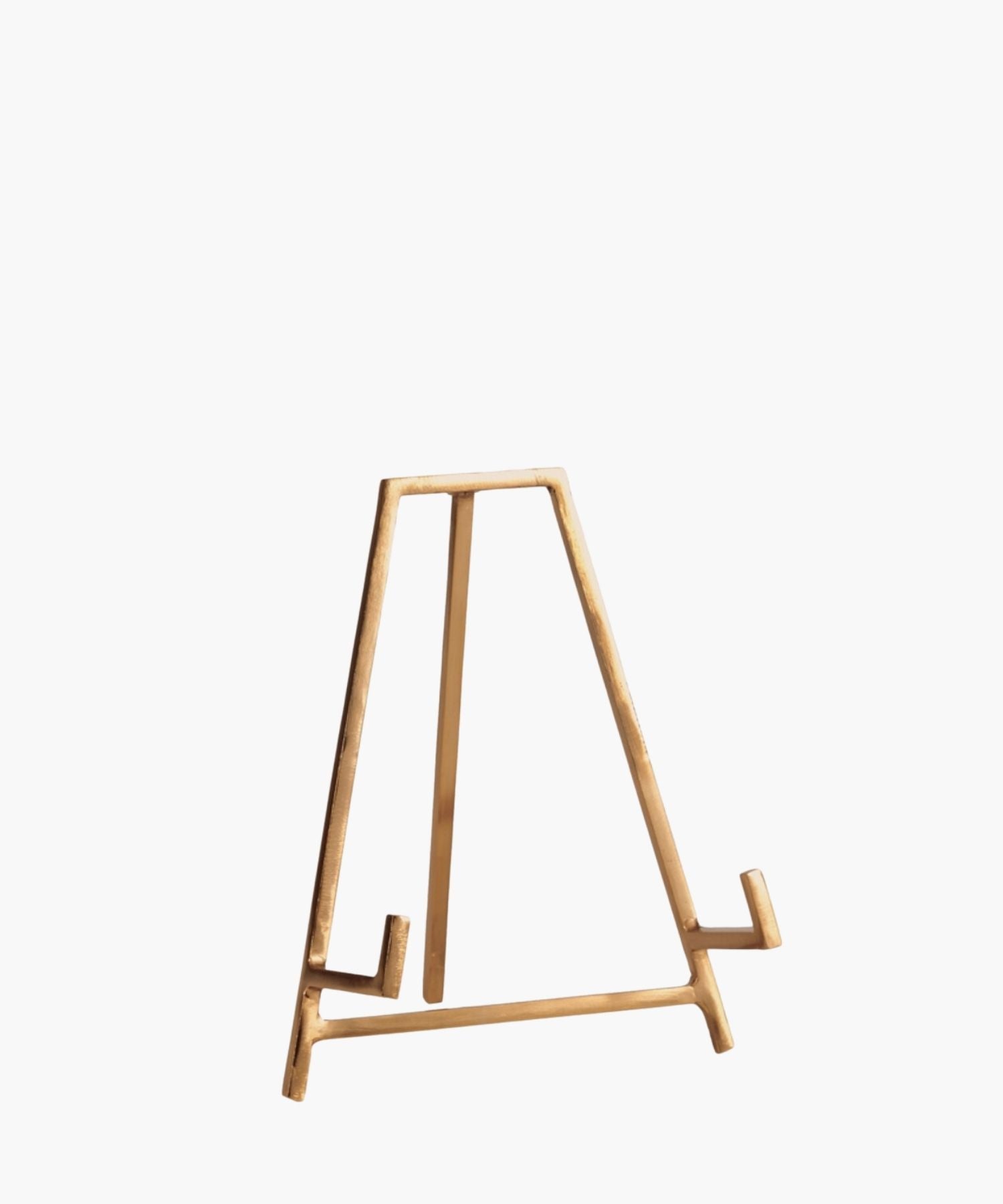 Small gold finished iron easel stand with a triangular shape and minimalistic design, conveying a simple and modern aesthetic.