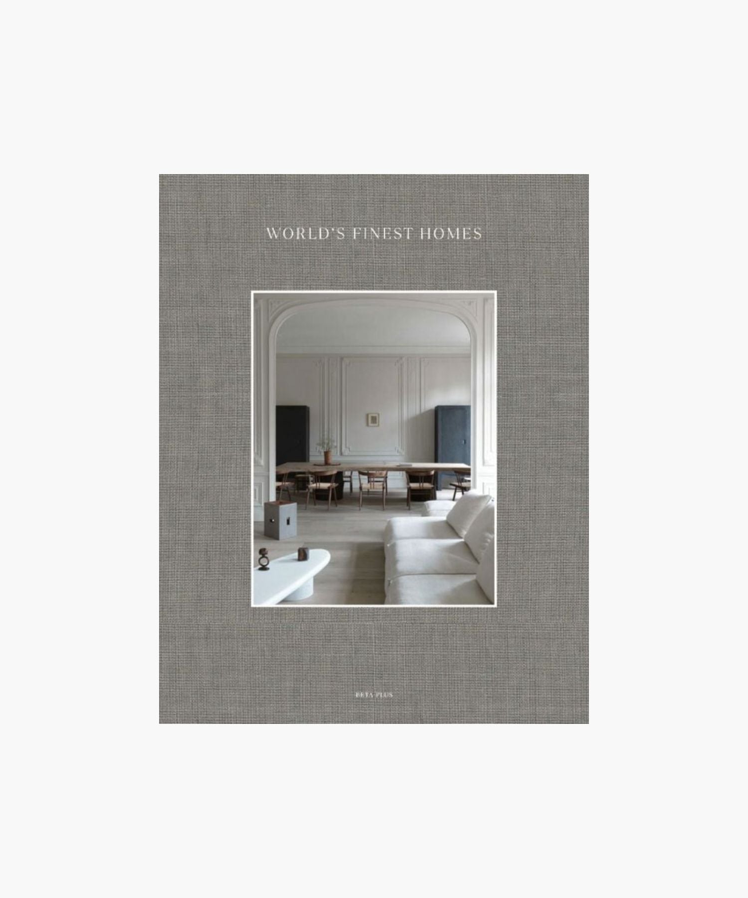 The cover of the book "World's Finest Homes" by Wim Pauwels features a minimalist living room. A neutral palette with a white sofa, elegant wood dining table, and soft lighting.