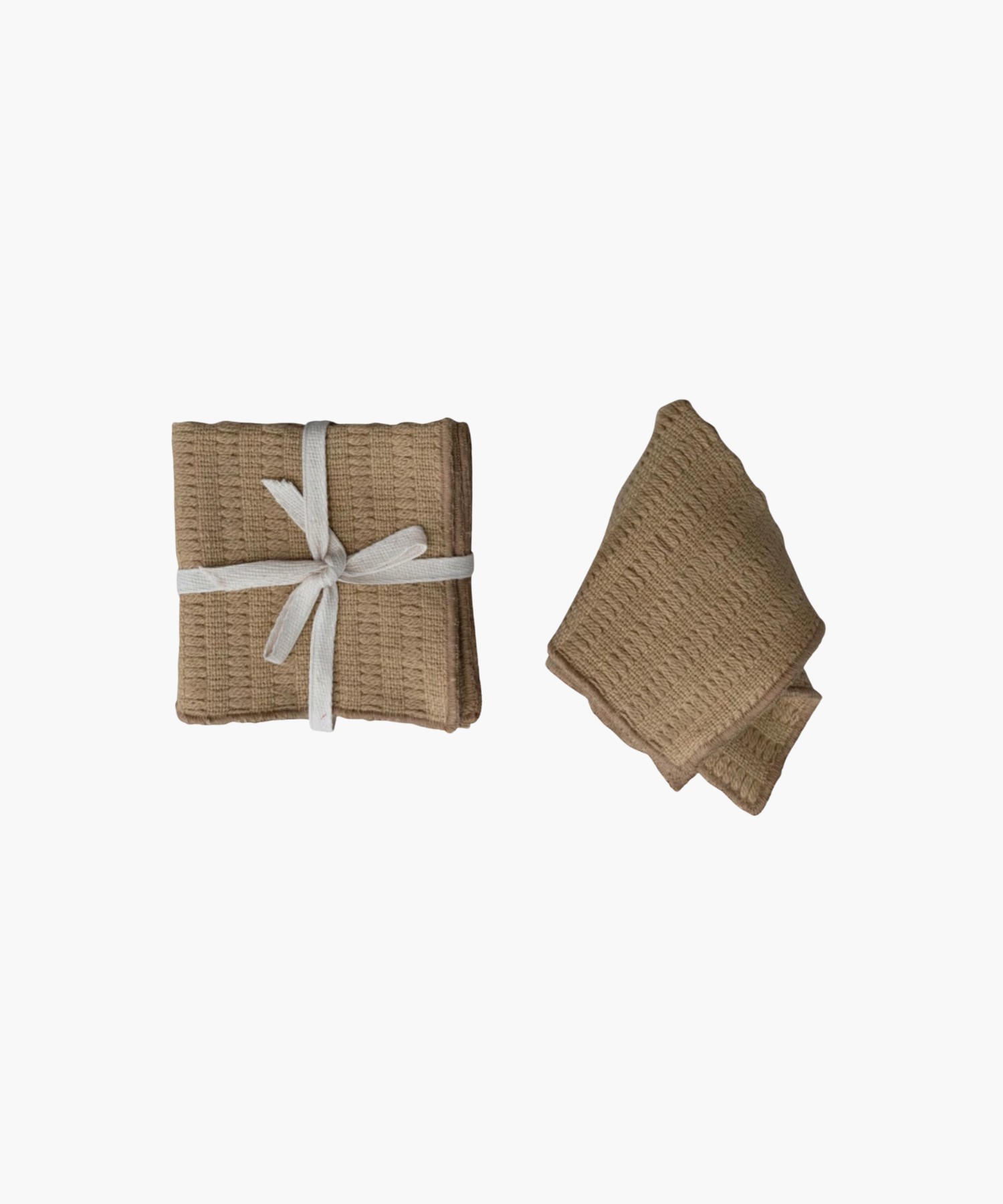 Two brown waffle-textured dish cloths; one folded and tied with a white ribbon, the other loosely folded. The tone is neutral and cozy.