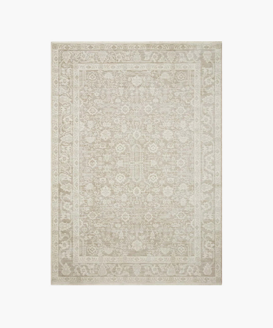 Elegant beige area rug with intricate floral and geometric patterns. The ornate border and subtle color variations create a classic and sophisticated tone.