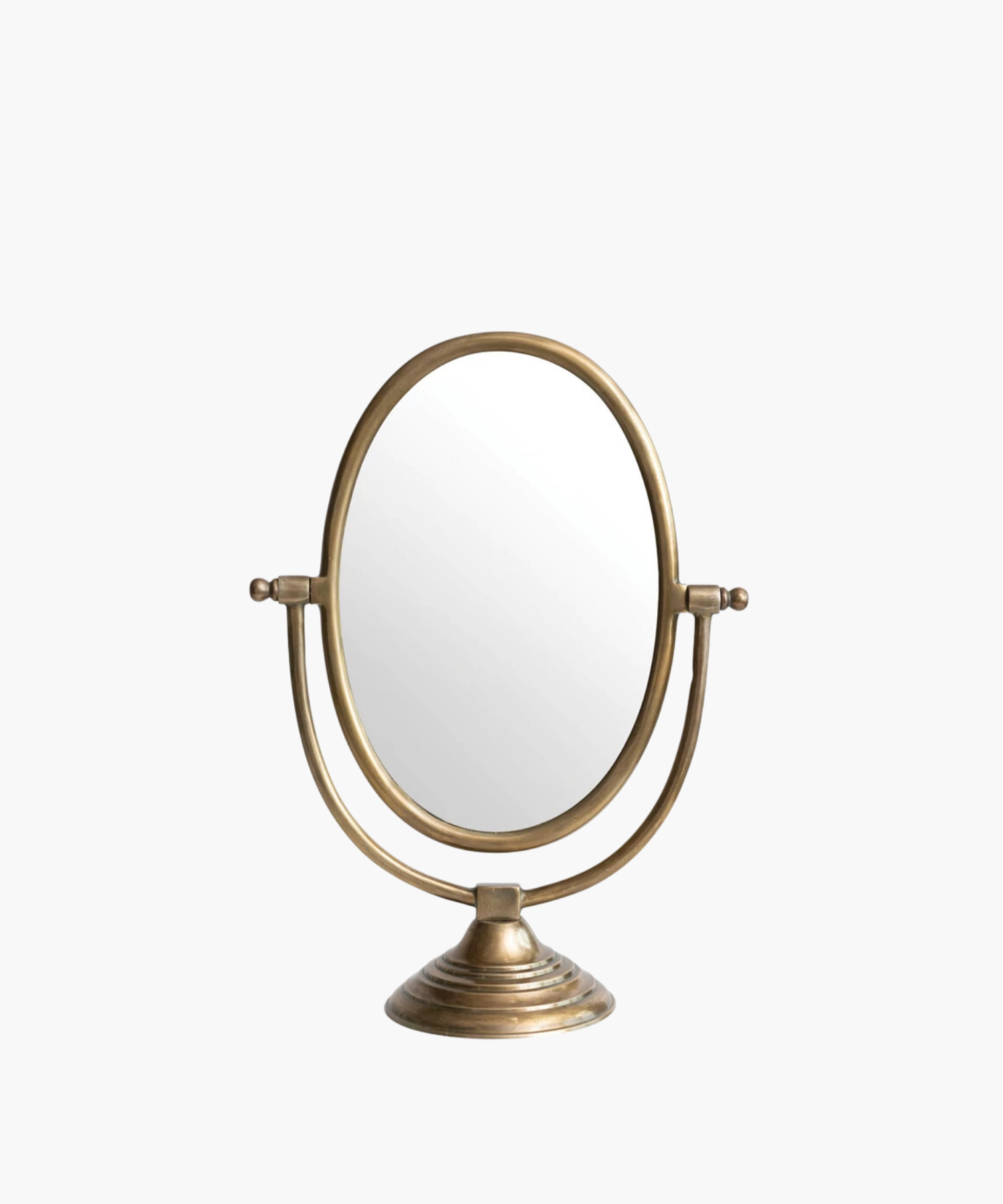 A vintage-style tabletop mirror with an oval shape and bronze finish. It features an adjustable frame resting on a decorative, circular base.