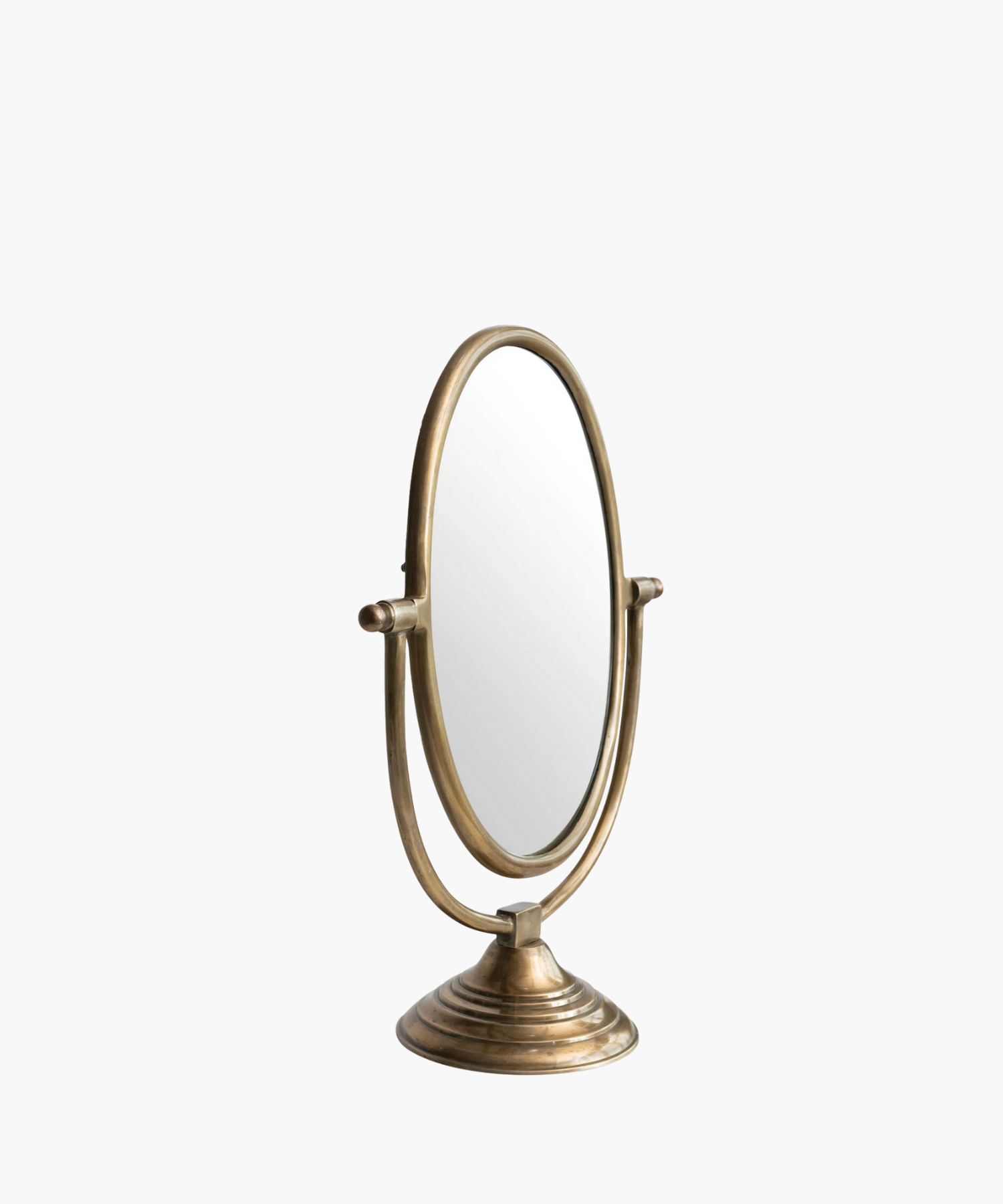 A vintage-style tabletop mirror with an oval shape and bronze finish. It features an adjustable frame resting on a decorative, circular base.