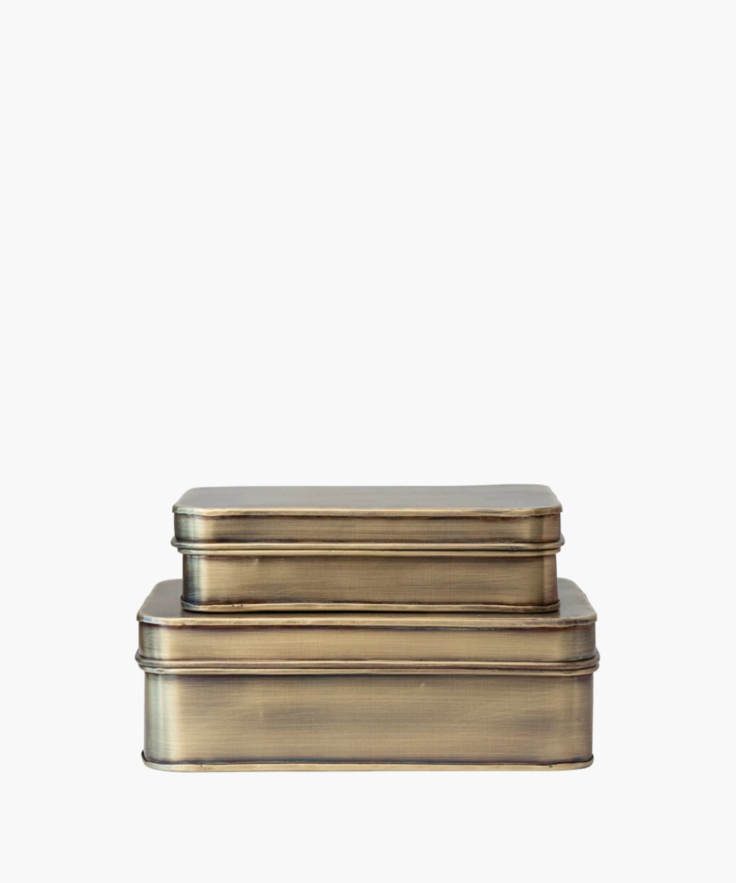 Two stacked vintage metal storage tins with a brushed brass finish. The tins are rectangular and convey a rustic, nostalgic feel against a white background.