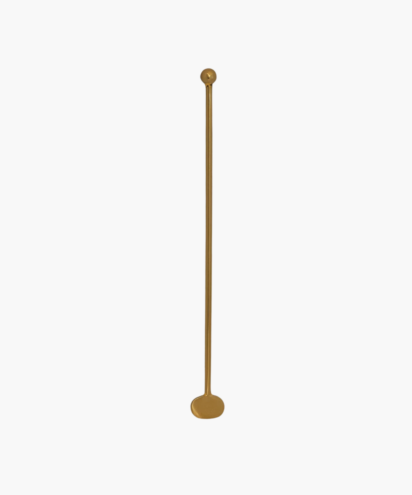 A long, slender brass cocktail stirrer with a rounded base and a small, spherical top placed against a plain white background.