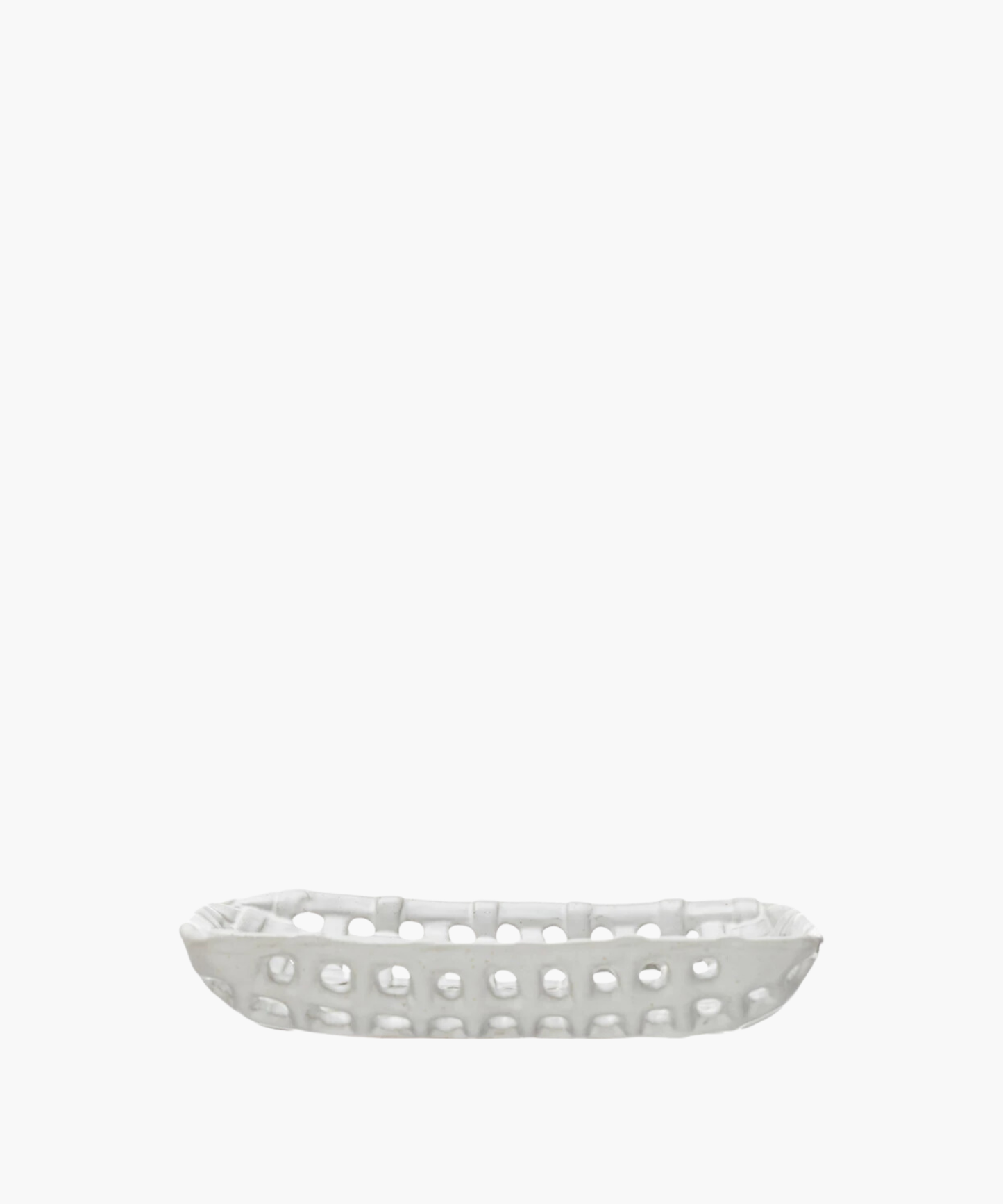 A white, rectangular ceramic basket dish with an open lattice design. The dish has a smooth finish and a contemporary look, evoking a minimalist style.